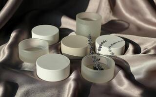 A group of white vases sitting on a satin cloth photo