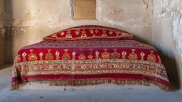 Ornate Red Carpet Adorns Ancient Bedding in Rustic Room. photo