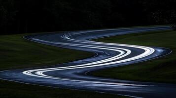 Winding Road at Night with Streaking Lights Creating Motion Blur Effect. photo