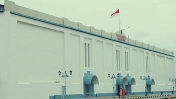 Elegant White Building with Flag and Arched Entrances video
