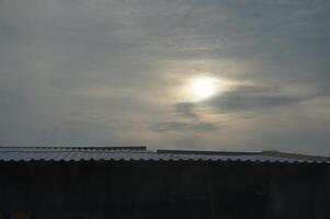 The sun is shining through the clouds photo