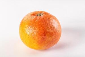 An orange on a white surface photo