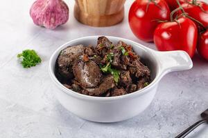 A bowl of beef with vegetables and garlic photo