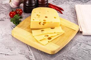 A cheese slice on a cutting board photo