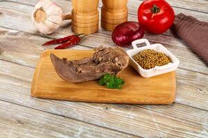 A meat dish with spices and herbs on a cutting board photo