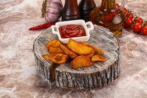 A plate with some chips and ketchup on it photo
