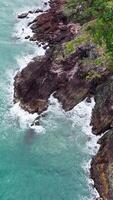 Drone footage captures the rugged coastline of Port Douglas, showcasing rocky cliffs and turquoise waters under natural daylight video