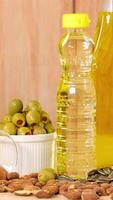 A close-up view of various healthy fats including oils, nuts, avocados, and butter on a wooden background video