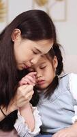 A mother gently comforts her child in a serene home setting, conveying warmth and care through soft lighting and close interaction video