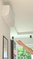 Using remote control to adjusting temperature on air conditioner video