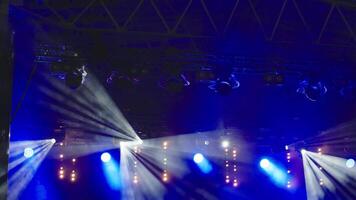 Stage with bright concert lighting, spotlights and smoke effects prepared for live music performance video