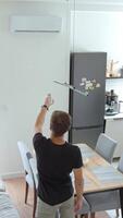 Man Using Remote Control to Adjusting Temperature on Air Conditioner video