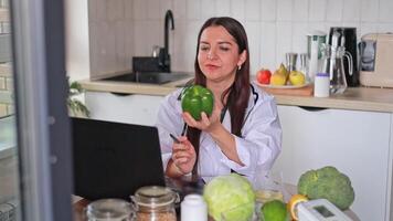 A nutritionist works with patients online at a table with fruits and vegetables. Fresh food promotes a healthy lifestyle and strengthens the body. Health and diet concept, clinic, wellness. video
