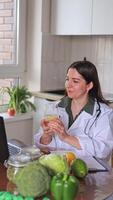 A nutritionist doctor conducts an online consultation with patients at a table. The benefits of drinking water with lemon. Water balance. Diet, detox, fitness. video
