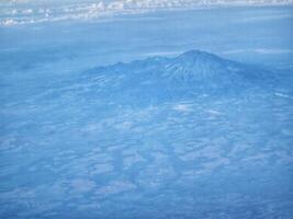 Aerial View of Mountain Landscape with Blue Tones and Cloudscape Scenery photo