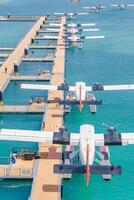 Amazing aerial seaplane view floating dock planes parking before departure takeoff luxury travel vacation tropical island getaway seaside adventure scenic ocean horizon sky photo