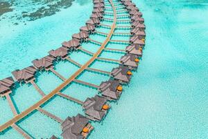Vacation stunning aerial view water villas tropical paradise crystal clear lagoon, turquoise sea, sunny skies, beautiful natural surroundings creating the perfect luxury beach and ocean luxury getaway photo