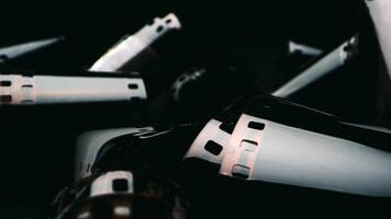 Photographic film isolated on a dark background, evoking a vintage and nostalgic feel. Close-up of a roll of film showing its perforated edges and smooth surface. photo
