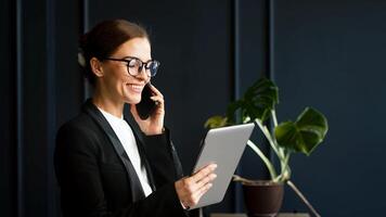 Focused middle-aged businesswoman working with a tablet in a modern office. Perfect for themes of productivity, technology, and professional work environment photo
