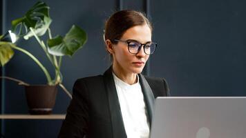 A female accountant or economist working late at the office. Ideal for topics related to finance, night work and professional dedication. photo