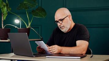 Businessman in a modern office working on a laptop. Concept of productivity and success in a dynamic work environment. photo