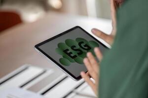 ESG sustainability focus with digital tablet displaying ESG concept photo