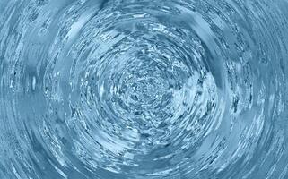 Vortex of swirling clear water with reflections and turbulence captured in a top-down motion blur spiral pattern photo