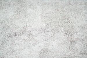 The texture of the fabric on the carpet is light gray photo