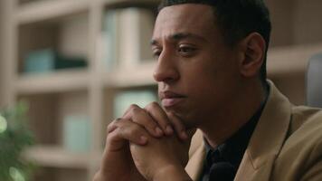 Close up face African American man ethnic thoughtful puzzled businessman pensive business entrepreneur office manager worker CEO think difficult problem solution deep thoughts thinking question doubt video