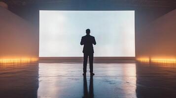 A man standing in front of a large screen photo
