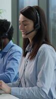 Helpline callcenter multiethnic business workers working online computer office customer service call center diverse smiling Caucasian Indian women African man in headset speak work pc helping client video