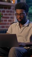 African American man businessman business employer typing laptop in night office overtime online studying deadline task in evening smiling guy male CEO manager programmer computer working web search video