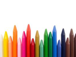 A row of colored crayons on a white background photo