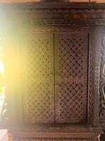 A wooden door with a sun shining through it photo