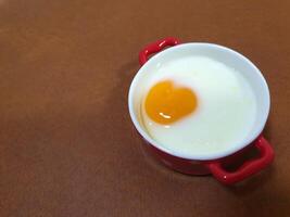 A small bowl with an egg in it photo