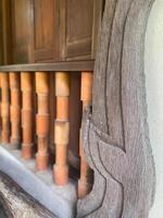 A wooden railing with a carved design on it photo