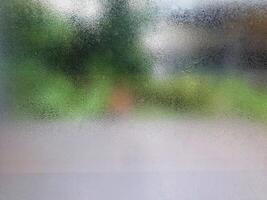 A blurry view of a window with a blurred background photo