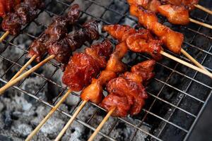 A grill with skewers of meat on it photo