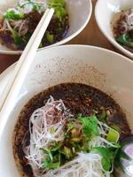 A bowl of soup with noodles and vegetables photo