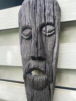 A wooden face mask with a beard and beard photo