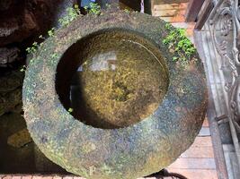 A large stone bowl with a small hole in it photo