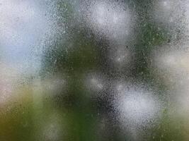 Rainy window with blurred background photo