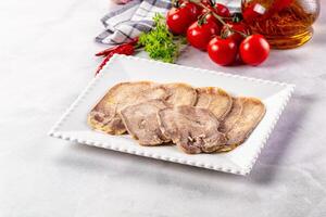 A plate with meat and vegetables on a white background photo