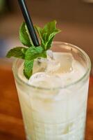 Refreshing minty lemonade with ice cubes in a glass photo