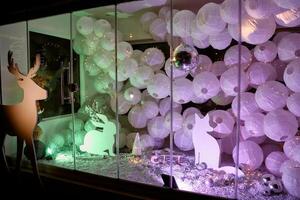 Festive window display with paper lanterns and silhouette decorations photo