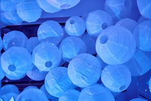 Blue lanterns illuminating indoor ceiling with soft glowing light photo