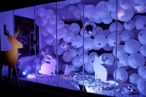 Enchanting winter display with silhouettes and lanterns in soft purple lighting photo