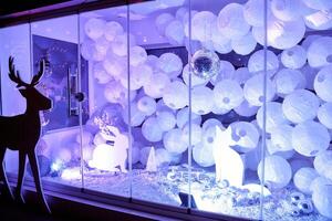 Magical winter wonderland display with reindeer silhouettes and festive lights photo
