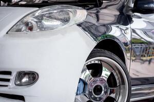 A close up of a white car with chrome wheels photo