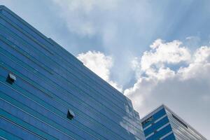 A blue building with a blue sky and clouds photo